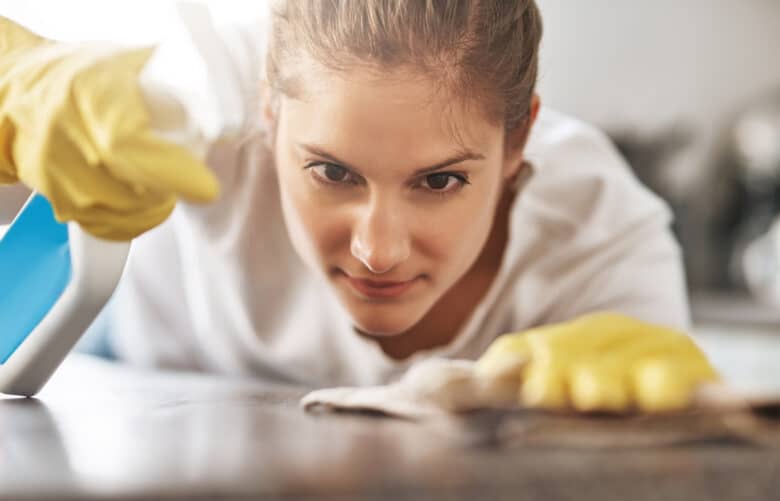 Cropped shot of a young woman cleaning her home