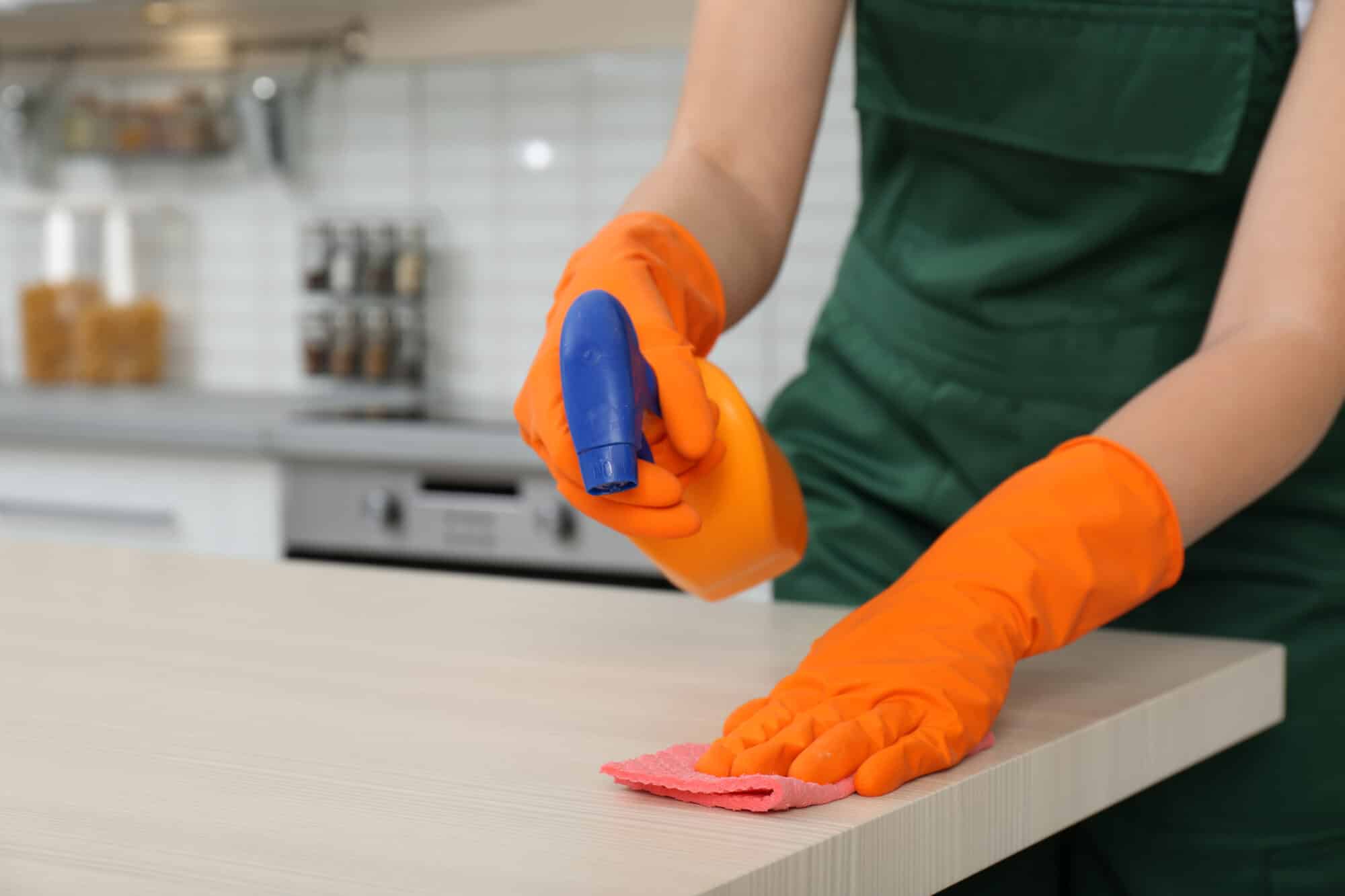 Female janitor cleaning table with rag in kitchen, closeup. Space for text; Shutterstock ID 1272011038; purchase_order: Multi DES (Fresh) / Ultra DES / Spray; job: ; client: ; other: